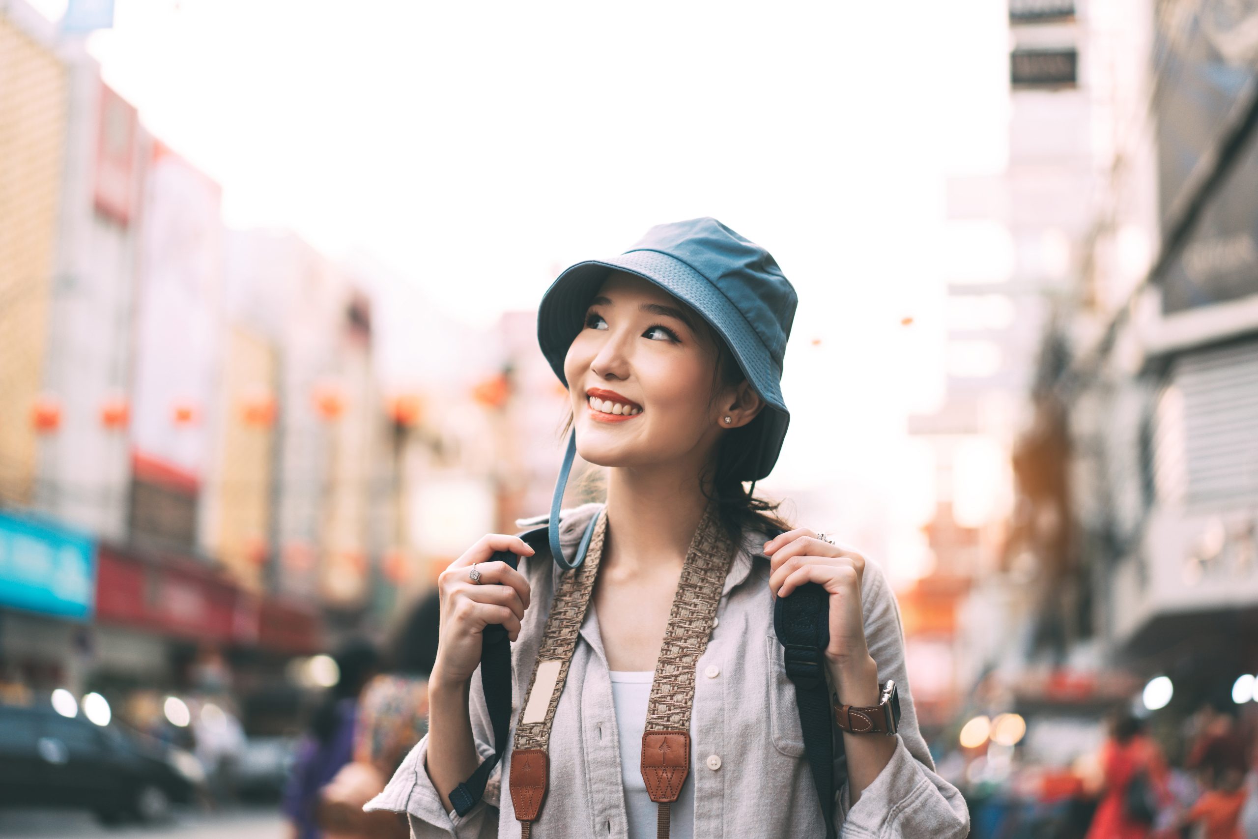 Walking young adult asian woman traveller in city lifestyle at o
